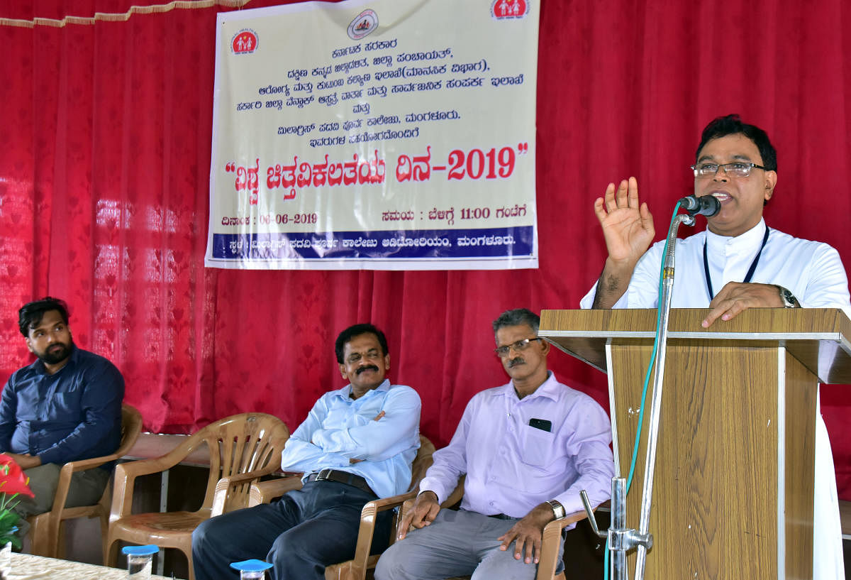 caption: Milagres Educational Institutions Campus Director Fr Michael Santhumayor addressing the gathering after inaugurating the programme organised to mark World Schizophrenia Day at Milagres Pre-University College auditorium on Thursday.