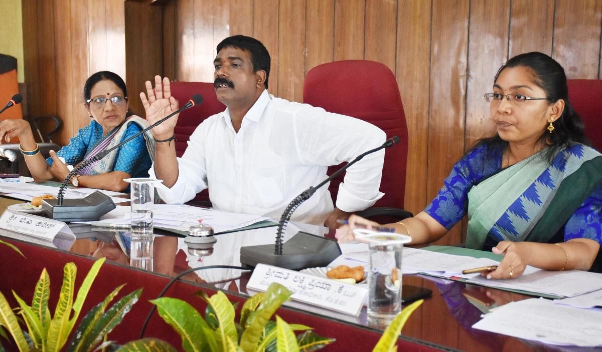 Zilla Panchayat President B A Harish chairs a special general meeting of Kodagu Zilla Panchayat at Old Fort Hall in Madikeri on Friday. Zilla Panchayat Vice President Lokeshwari Gopal and Zilla Panchayat CEO K Lakshmi Priya look on.