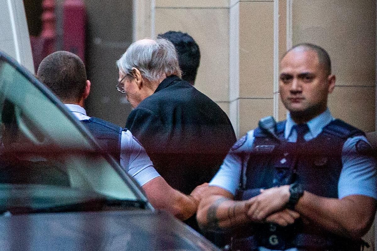 Jailed Australian Cardinal George Pell (C) is escorted to a white van as he leaves Victoria State's Supreme Court in Melbourne on June 6, 2019. - Prosecutors insisted the conviction of Australian Cardinal George Pell for child sexual abuse was "unimpeacha
