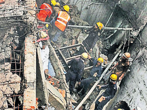 Firefighters and NDRF men at job after a fire broke out in a plastic factory at Mayapuri industrial estate in New Delhi on Thursday. PTI