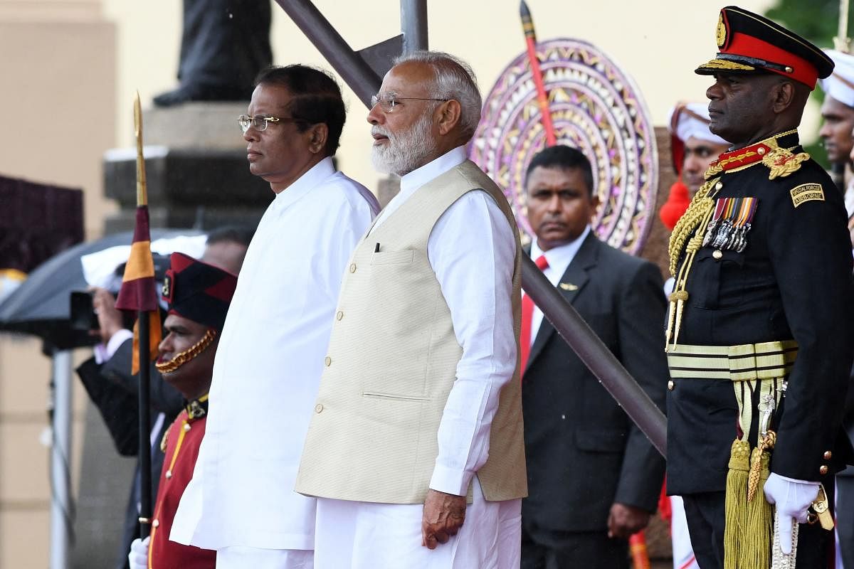 Indian Prime Minister Narendra Modi (C) and Sri Lankan President Maithripala Sirisena (L) attend a welcoming ceremony for Modi at the Presidential Secretariat, in Colombo. AFP photo