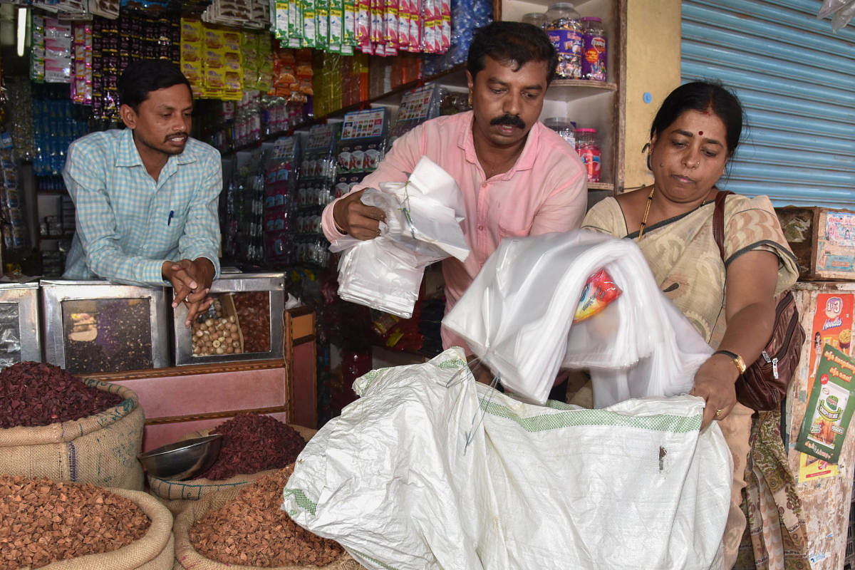 DH file photo of officials from KSPCB and BBMP raiding shops for using plastic bags.