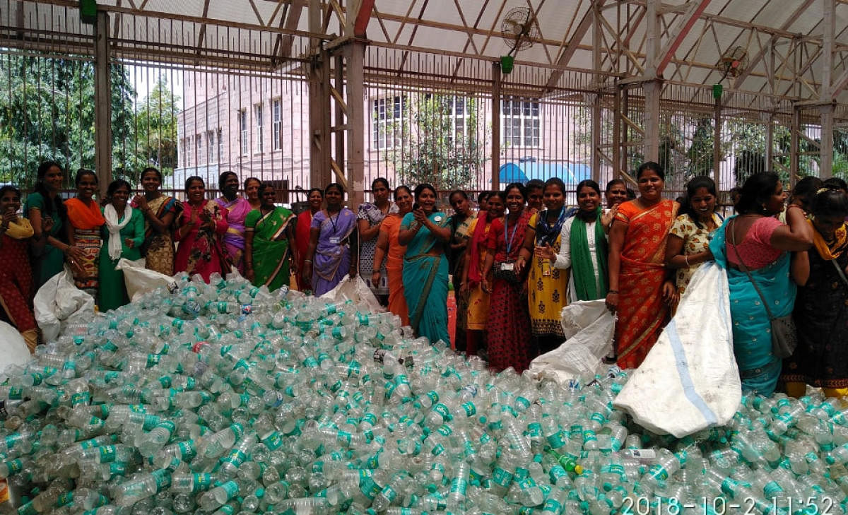 BBMP workers are seen calculating the amount of plastic waste collected during Plog Run at BBMP head office. DH file photo