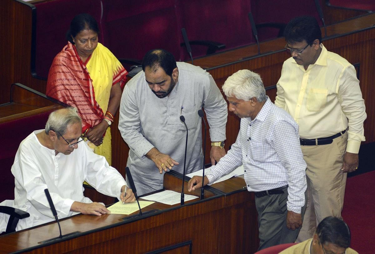 Bhubaneswar: Odisha Chief Minister Naveen Patnaik signs a register as he takes oath as an MLA at Odisha Legislative Assembly, in Bhubaneswar. (PTI File Photo)