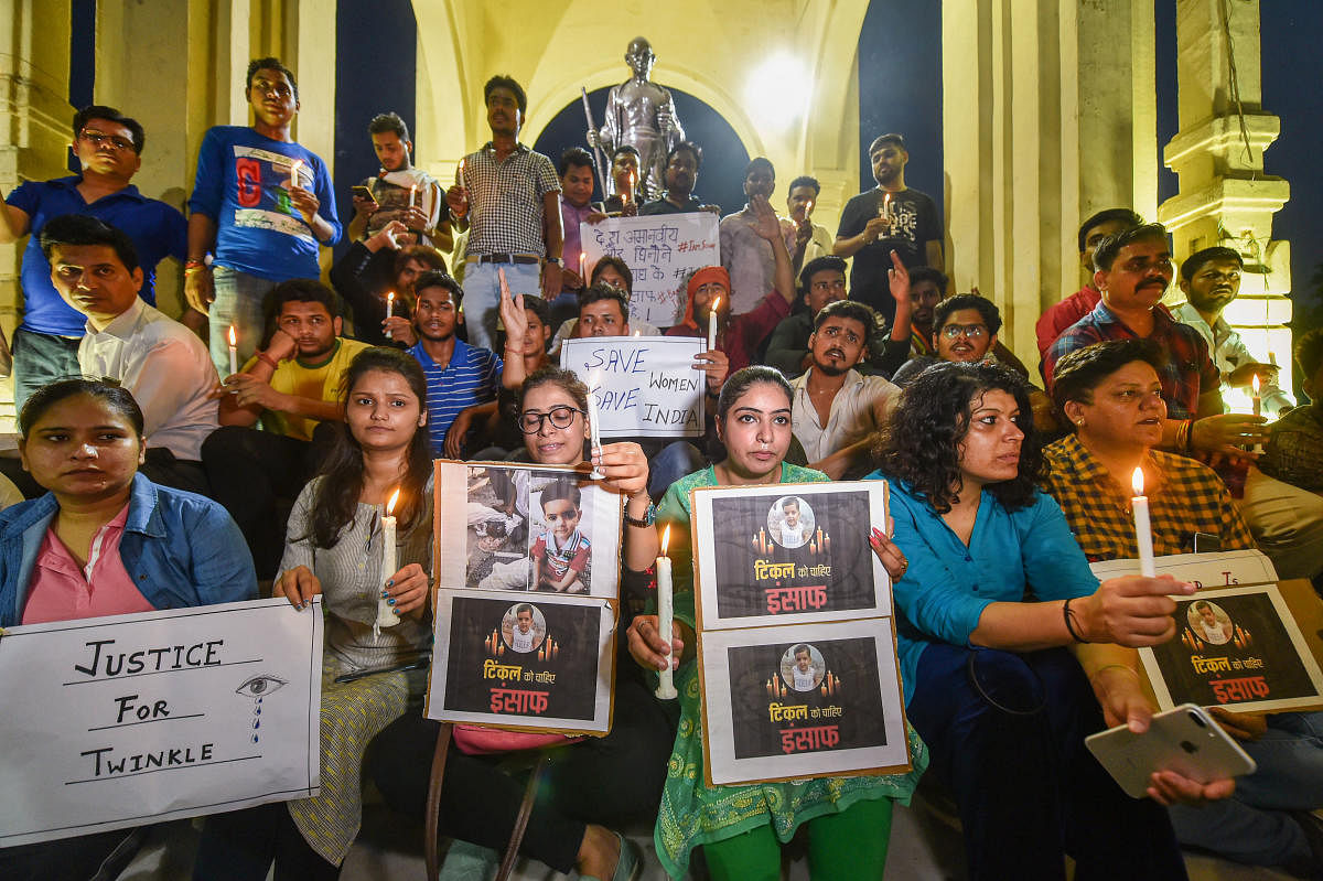 Lucknow: Lucknow University students participate in candle-march against killing of a girl in Aligarh, in Lucknow. (PTI Photo)