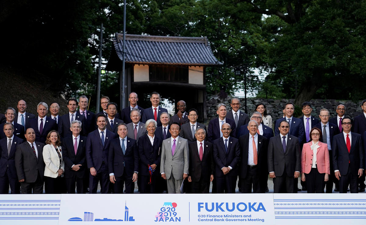 Japan's Finance Minister Taro Aso poses next to IMF Managing Director Christine Lagarde and Bank of Japan Governor Haruhiko Kuroda for a family photo during the G20 finance ministers and central bank governors meeting, in Fukuoka, Japan, June 8, 2019. Fra