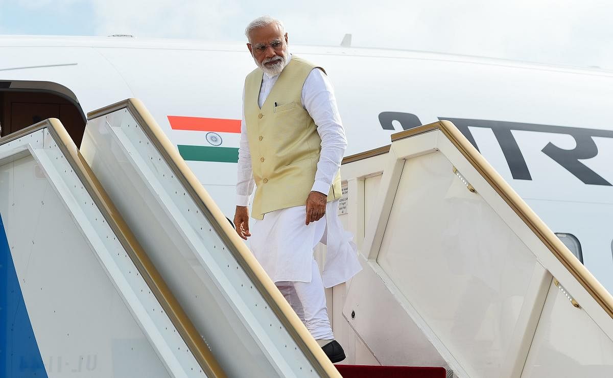 Indian Prime Minister Narendra Modi looks on from a plane on his departure at Bandaranaike International Airport in Katunayake, near Colombo, on June 9, 2019. - India's Prime Minister Narendra Modi on June 9 made an unscheduled stop at a Catholic church b