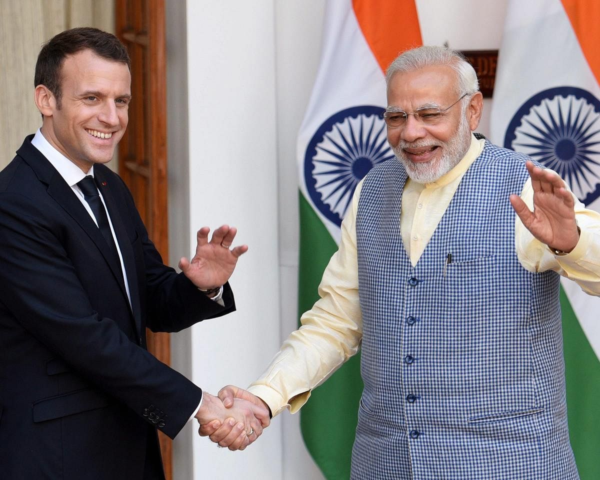 New Delhi: Prime Minister Narendra Modi shakes hands with French President Emmanuel Macron before their meeting at Hyderabad House in New Delhi on Saturday. PTI Photo by Vijay Verma (PTI3_10_2018_000066B)