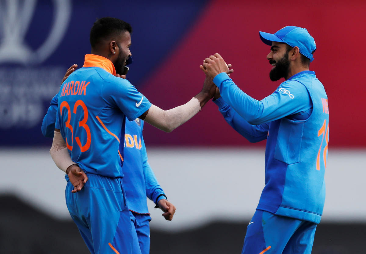 Virat Kohli and Hardik Pandya celebrate the wicket of Australia's Aaron Finch. Reuters