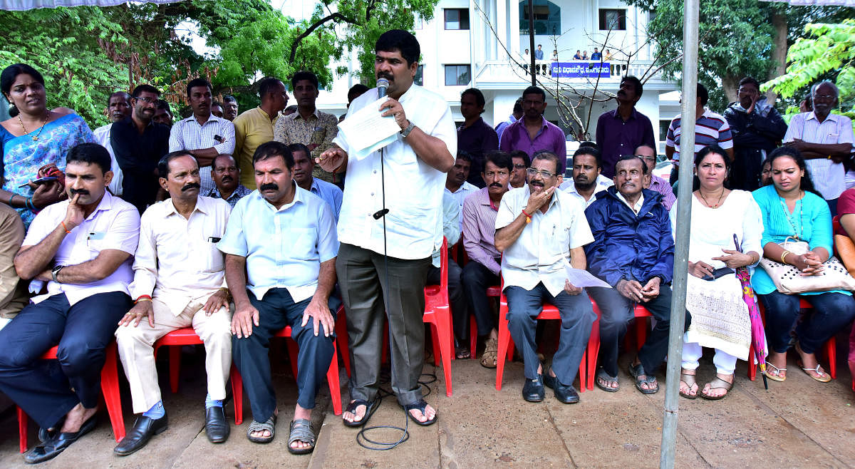 Mangalore City South MLA Vedavyas Kamath addresses protesters in front of the Mini Vidhana Soudha in Mangaluru on Monday.