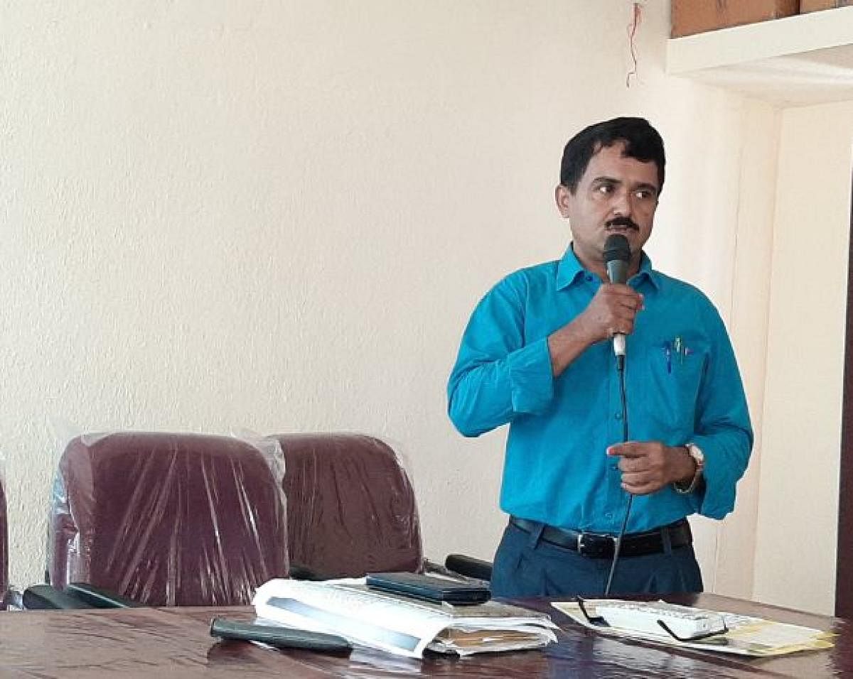 District Surveillance Officer Dr Vasudeva speaks at a meeting in Udupi.