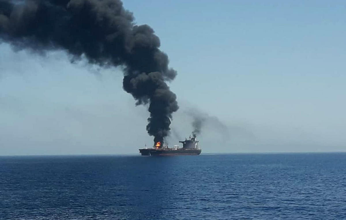 The crews of two oil tankers were evacuated off the coast of Iran today after they were reportedly attacked and caught fire in the Gulf of Oman, sending world oil prices soaring. (AFP Photo)