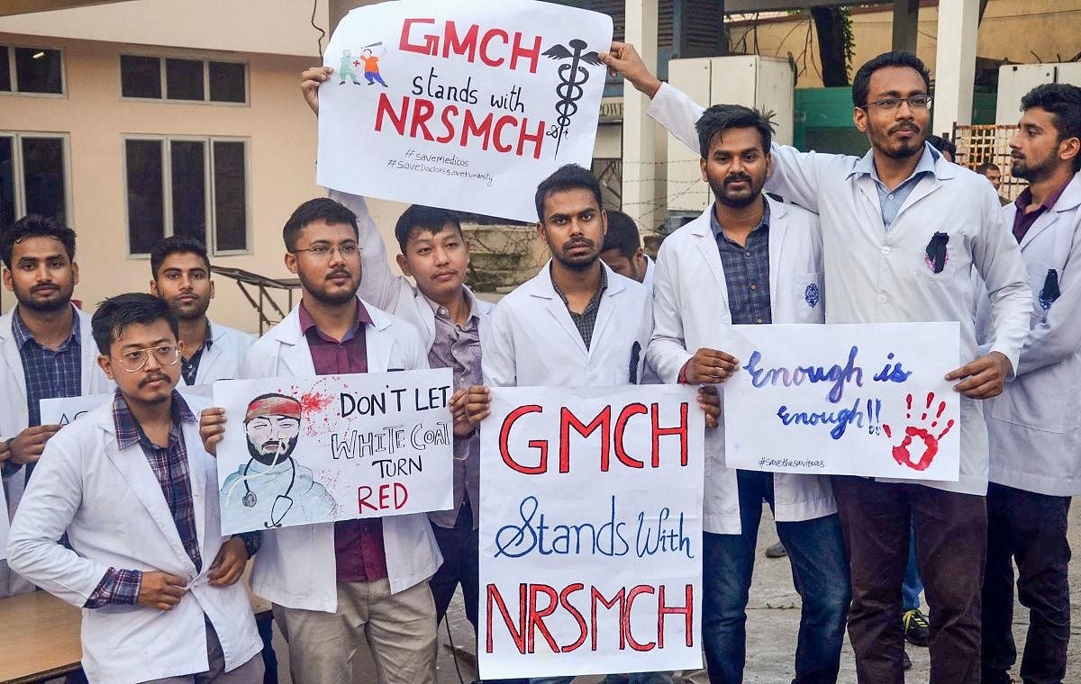 Medical students hold placards showing solidarity with the intern doctor who was assaulted in West Bengal, at Gauhati Medical College in Guwahati, Friday, June 14, 2019. PTI