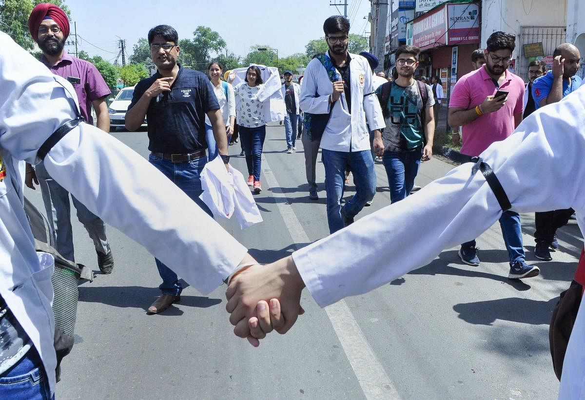 Doctors wore black bands to express solidarity with their protesting colleagues in West Bengal. (Photo PTI)