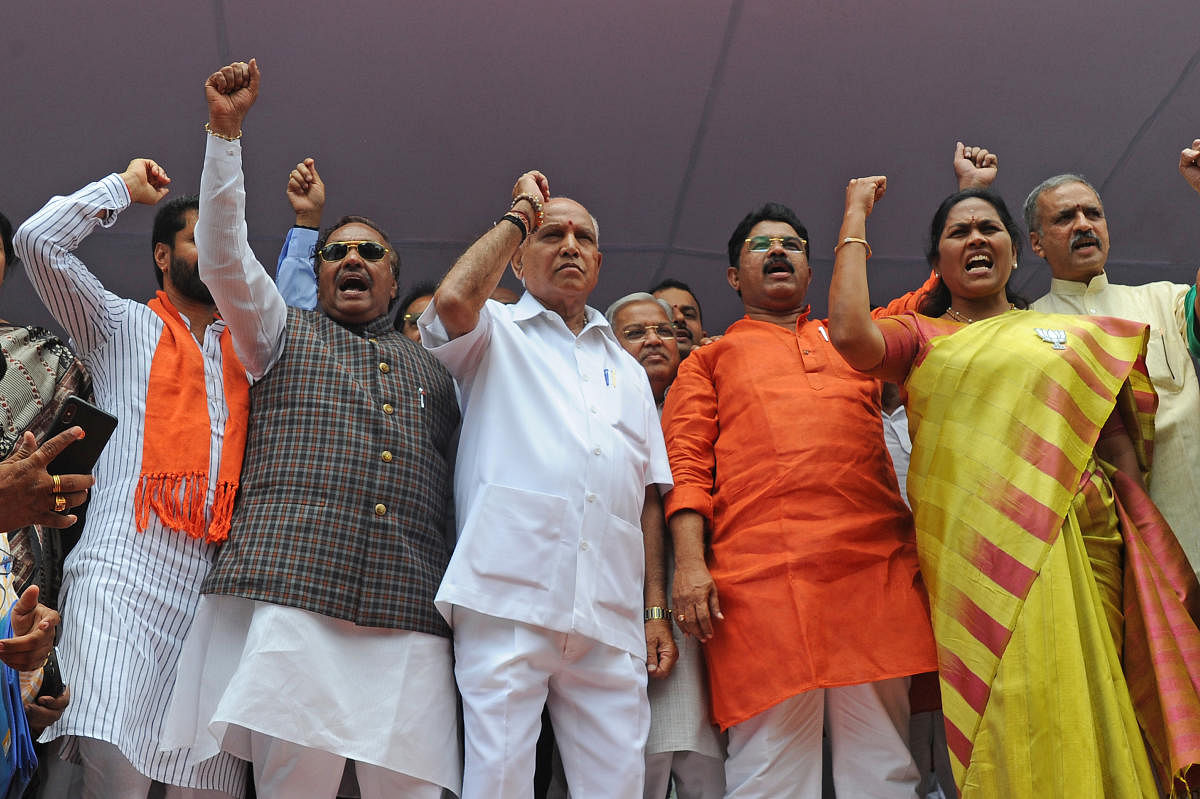 (From left) Legislator K S Eshwarappa, state BJP president B S Yeddyurappa, former deputy chief minister R Ashoka and Lok Sabha member Shobha Karandlaje raise slogans at a 48-hour protest of the party against government's decision to transfer land to JSW