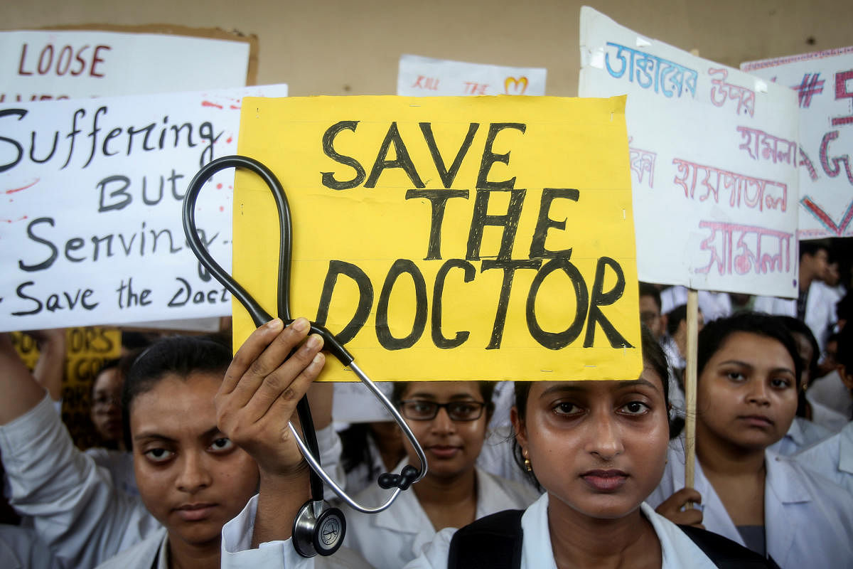 A doctor holds a placard at a government hospital during a strike demanding security after the recent assaults on doctors by the patients' relatives. (Reuters Photo)