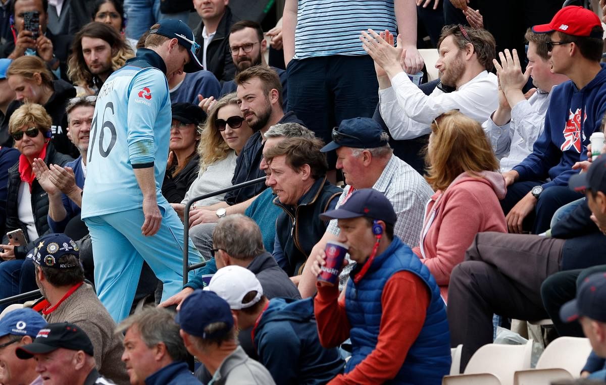 England's captain Eoin Morgan walks through the crowd after leaving the field with an injury during the 2019 Cricket World Cup group stage match between England and West Indies at the Rose Bowl in Southampton, southern England, on June 14, 2019. AFP)
