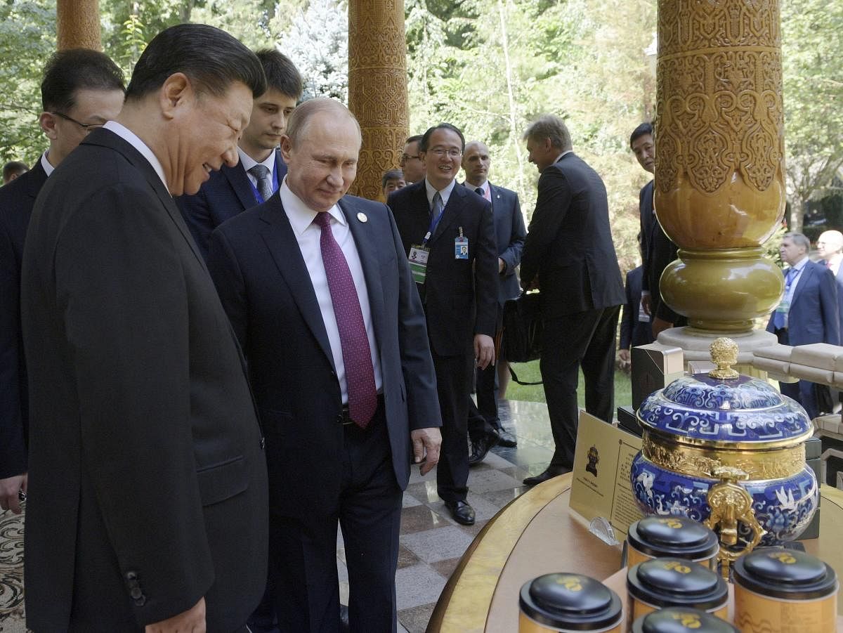 Russian President Vladimir Putin, second left, Chinese President Xi Jinping, left, attend a reception prior to the Conference on Interaction and Confidence Building Measures in Asia (CICA) in Dushanbe, Tajikistan. (AP Photo)