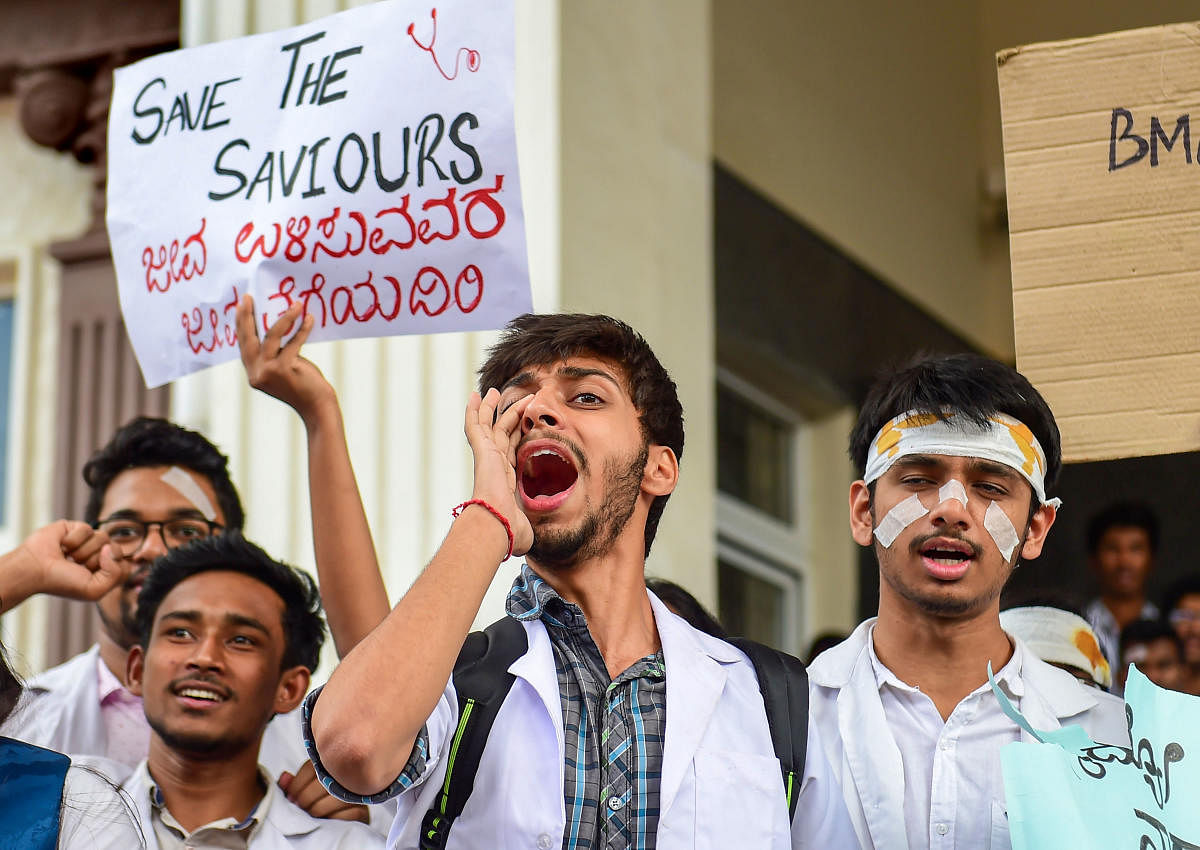 Medical students raise slogans during a demonstration protest to show solidarity with their counterparts against the assault in Kolkata, in Bengaluru, Friday, June 14, 2019. PTI