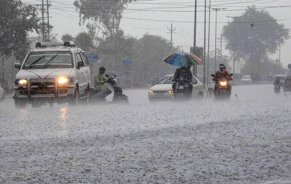 Commuters ride their vehicles during heavy pre-monsoon rains in Bhopal. PTI file photo