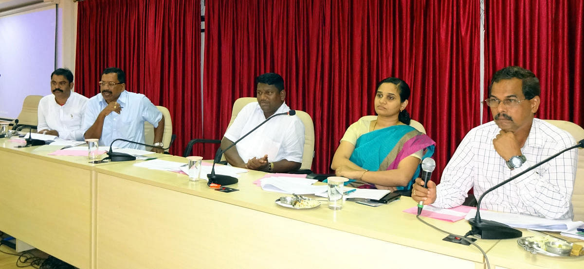 Zilla Panchayat President Dinakar Babu (centre) chairs the monthly KDP meeting in Udupi on Saturday. CEO Sindhu Rupesh and others are also seen.