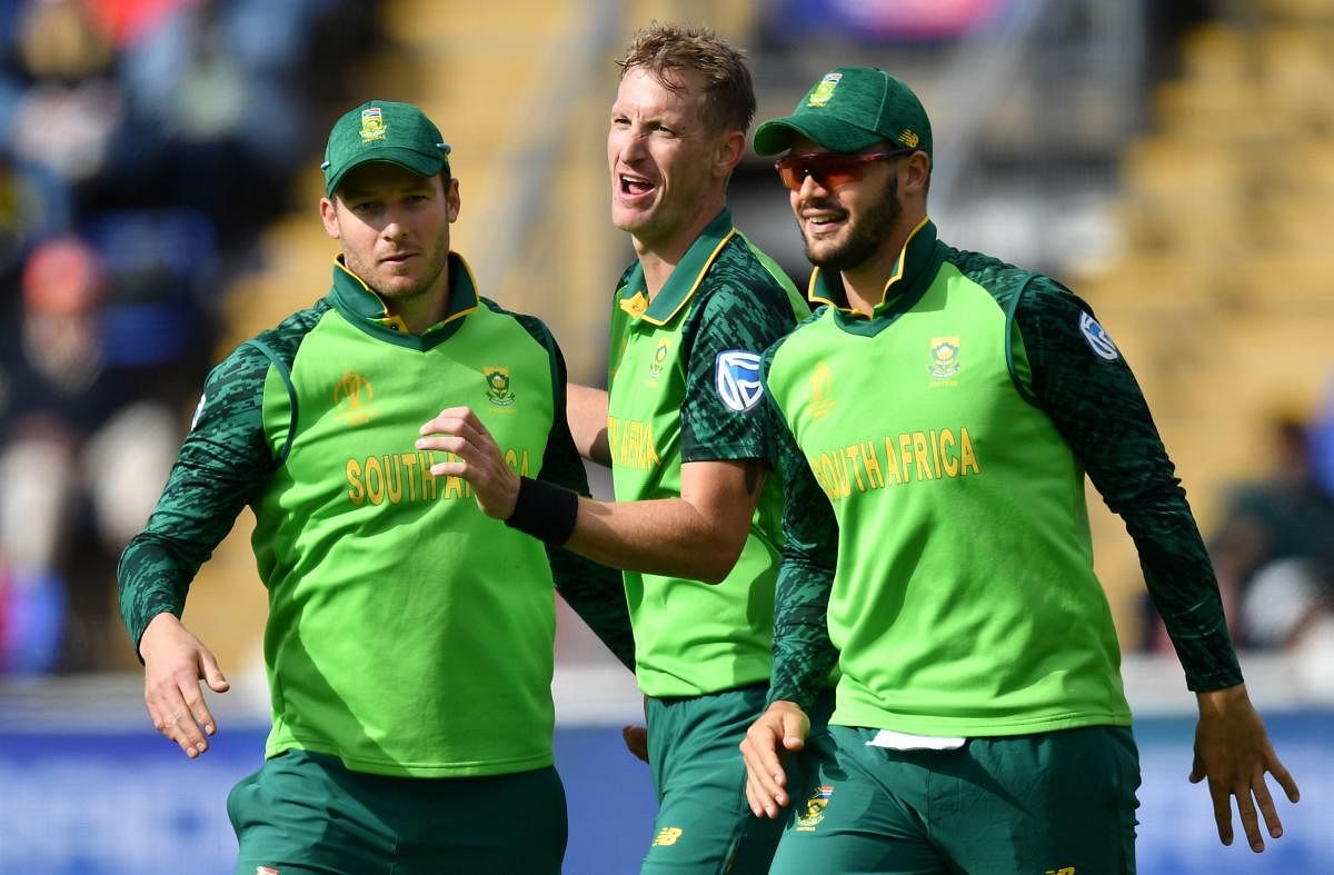 South Africa's Chris Morris (C) celebrates with teammates after the dismissal of Afghanistan's Ikram Ali Khil during the 2019 Cricket World Cup group stage match between South Africa and Afghanistan at Sophia Gardens stadium in Cardiff, South Wales, on Ju