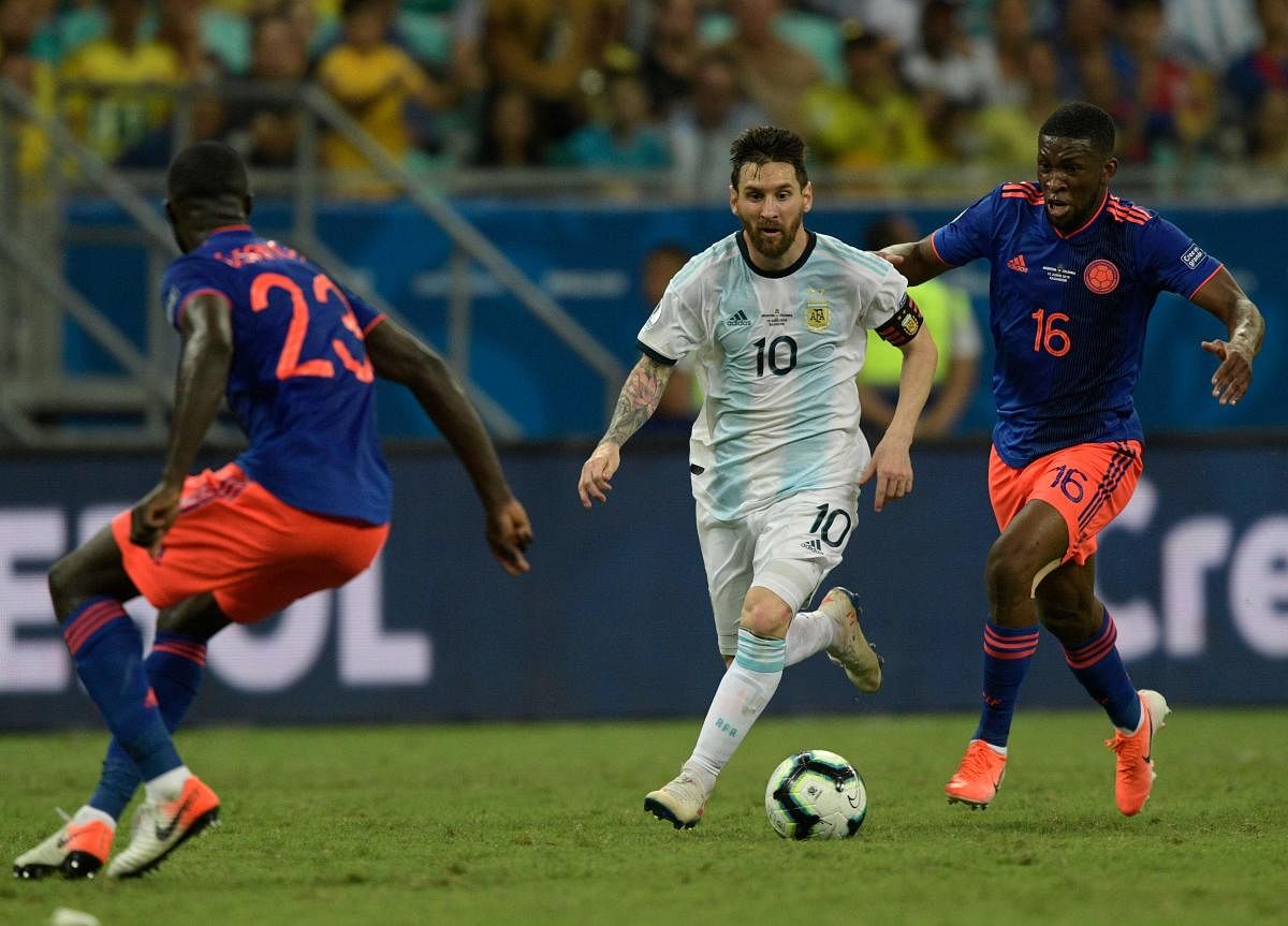 Argentina's Lionel Messi (C) is marked by Colombia's Davinson Sanchez (L) and CJefferson Lerma during their Copa America football tournament group match at the Fonte Nova Arena in Salvador, Brazil, on June 15, 2019. (AFP)