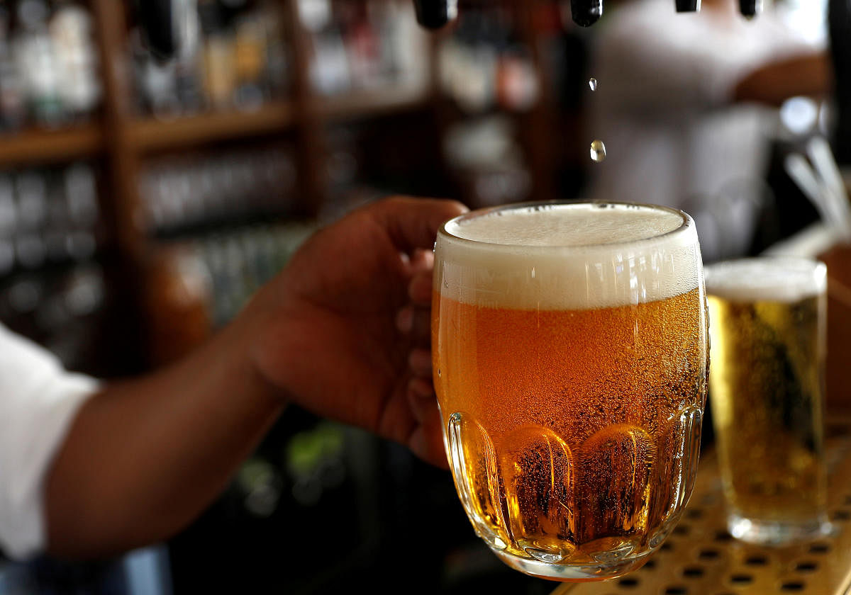 A pint of beer is poured into a glass in a bar (REUTERS Photo)