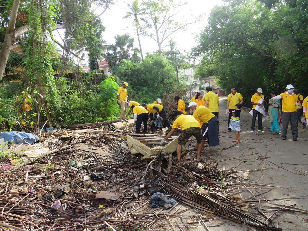 Volunteers clear garbage on a road in Boloor in Mangaluru.