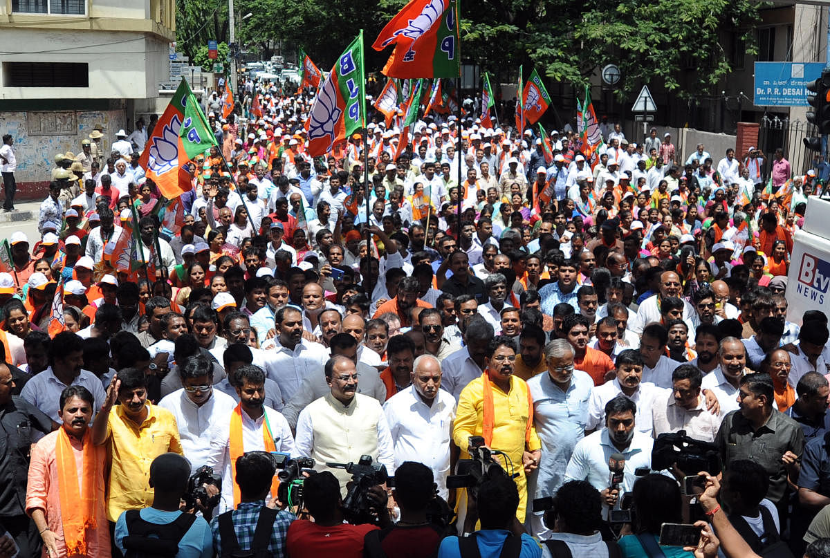 State BJP president Yeddyurappa and other leaders along with party workers take out a rally towards chief minister's home office, opposing the government's decision to transfer land to Jindal Steel, in Bengaluru on Sunday. DH Photo/Pushkar V