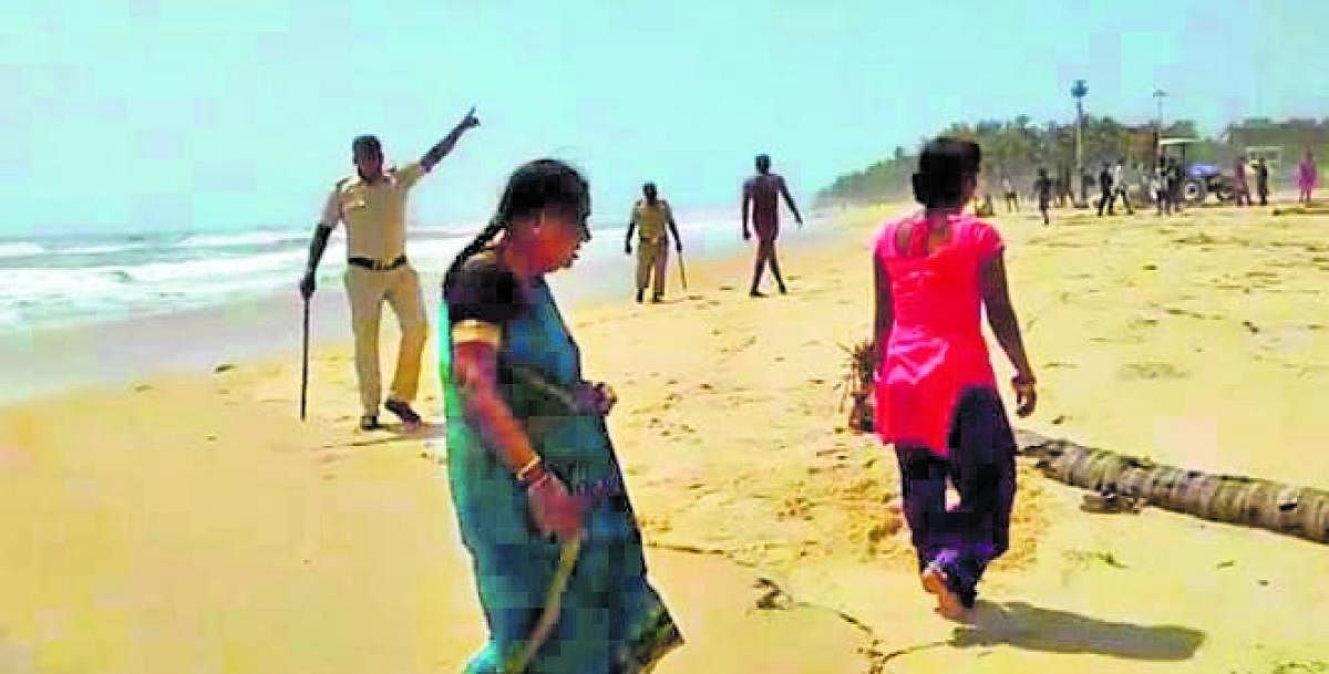 A video grab of a home guard personnel warning tourists from entering beach at Malpe on Sunday.