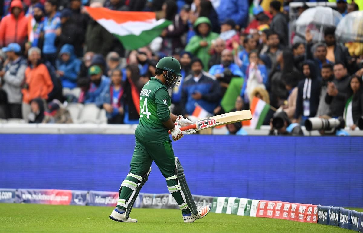 Pakistan's captain Sarfaraz Ahmed walks back to the pavilion after his dismissal during the 2019 Cricket World Cup group stage match between India and Pakistan at Old Trafford in Manchester, northwest England, on June 16, 2019. (AFP)
