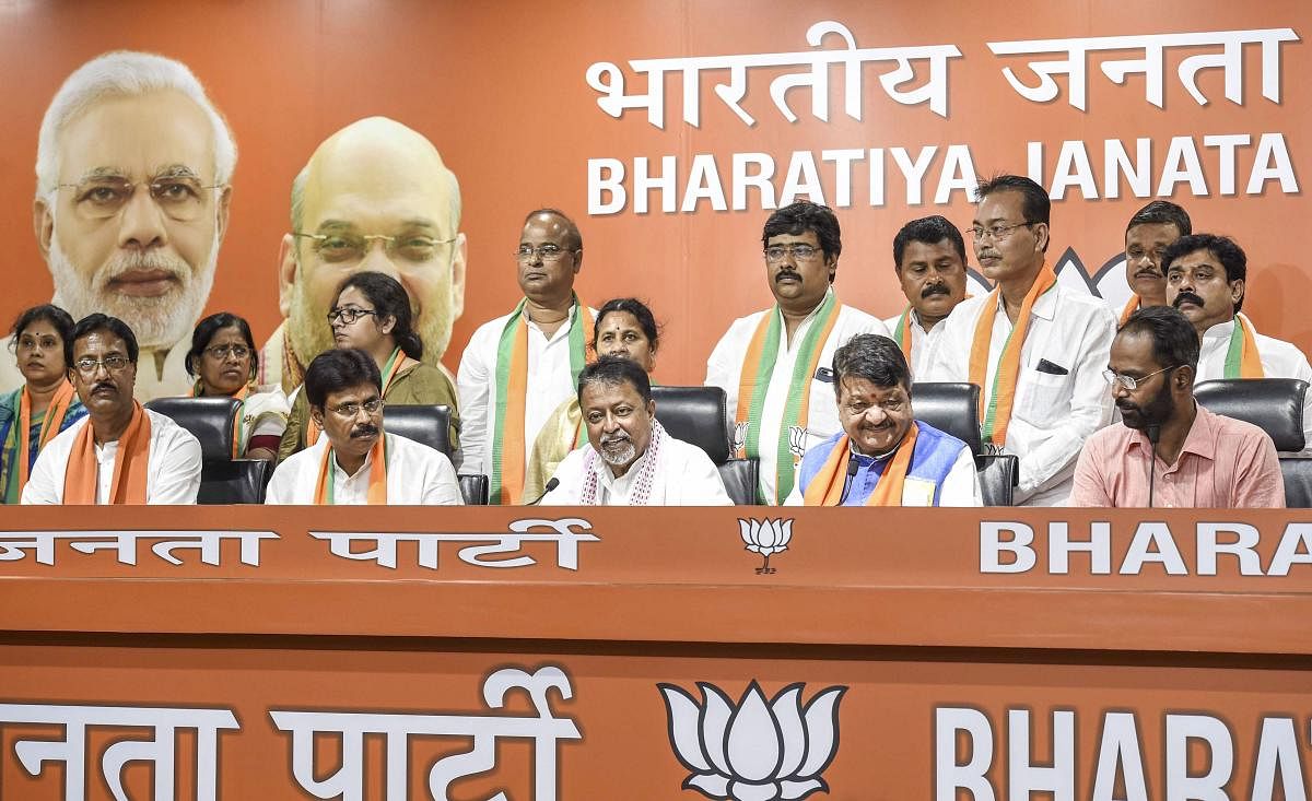 TMC MLA from Bongaon Biswajit Das (2L) joins BJP in the presence of party's West Bengal leaders Kailash Vijayvargiya and Mukul Roy, in New Delhi, Tuesday, June 18, 2019. Along with Biswajit Das, 12 TMC councillors and Congress spokesperson Prasanjeet Ghosh also joined the BJP. PTI