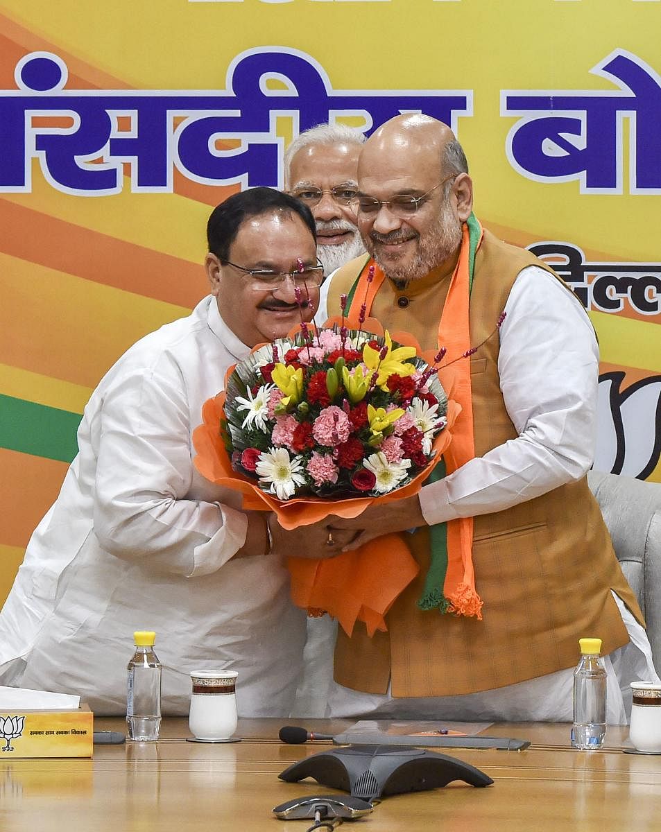J P Nadda being greeted by BJP chief and Home Minister Amit Shah. PTI