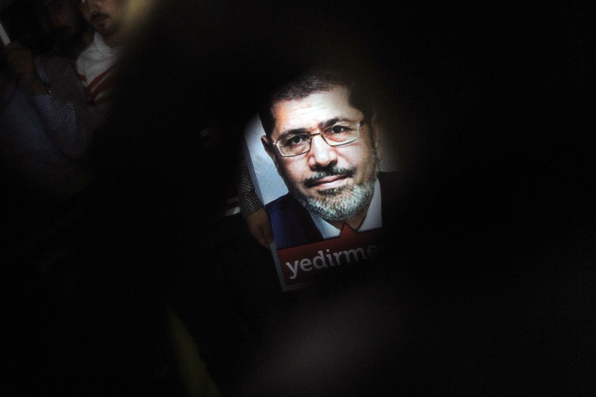 A poster of Egypt's President Mohamed Morsi is seen during a pro-Morsi demonstration in Istanbul. (AFP File Photo)