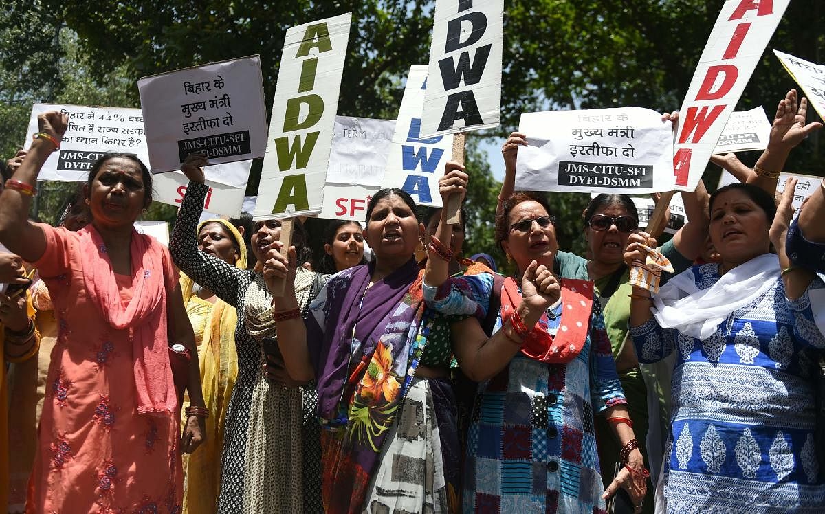 Indian women activists hold placards and shout slogans during a protest against the deaths of more than 100 children in Muzaffarpur in Bihar (AFP Photo)