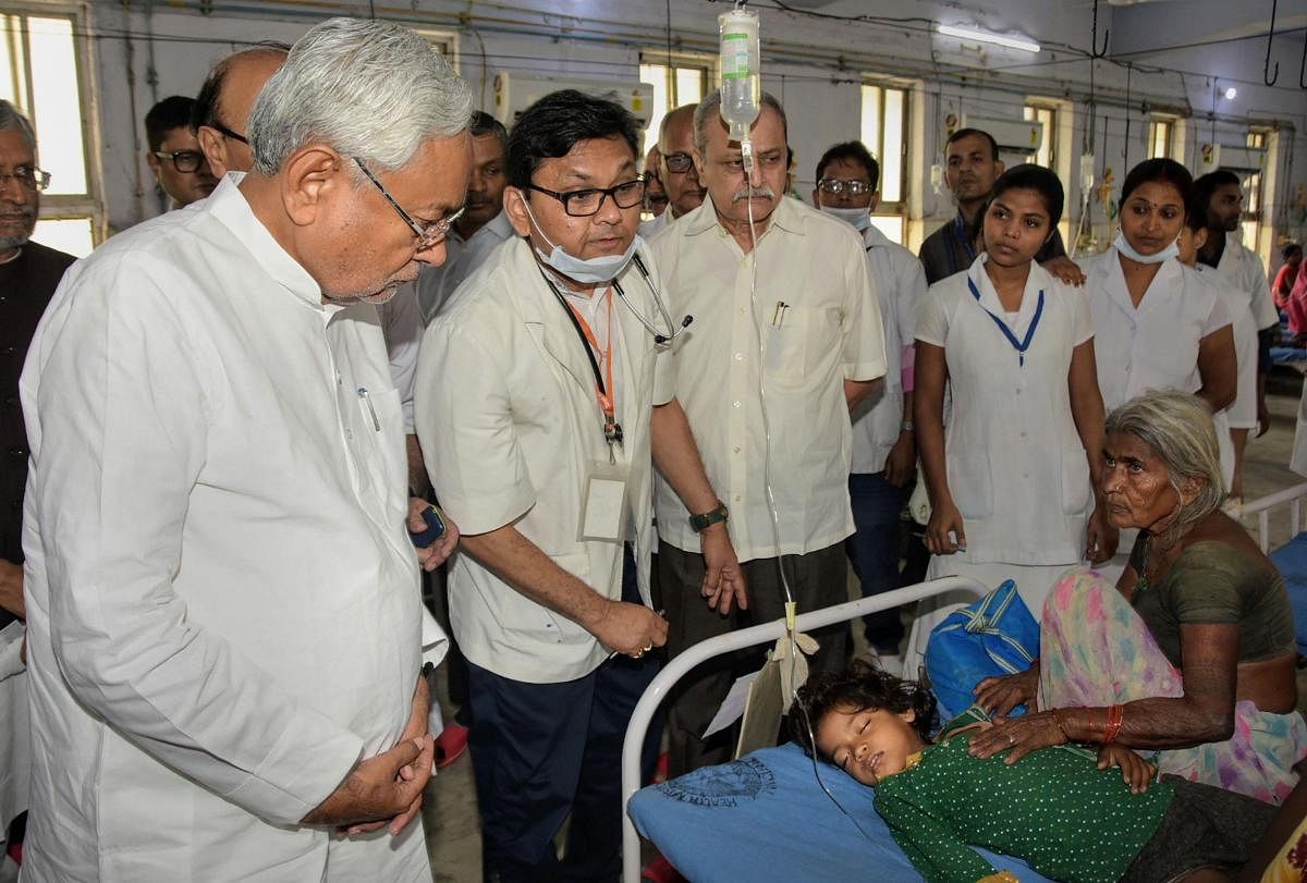 Muzaffarpur: Bihar Chief Minister Nitish Kumar along with deputy CM Sushil Kumar Modi visits children suffering from Acute Encephalitis Syndrome (AES) at a hospital in Muzaffarpur district. (PTI Photo)