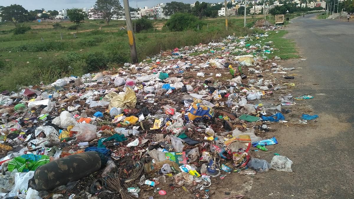 Garbage dumped beside a road at Vijayanagar, in Mysuru. Dh-file photo