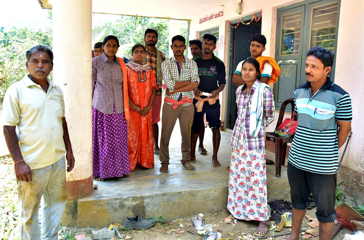 Members of the indigenous tribe Malekudiya are seen at the colony in Banjarumale, which will receive electricity connection within a week.