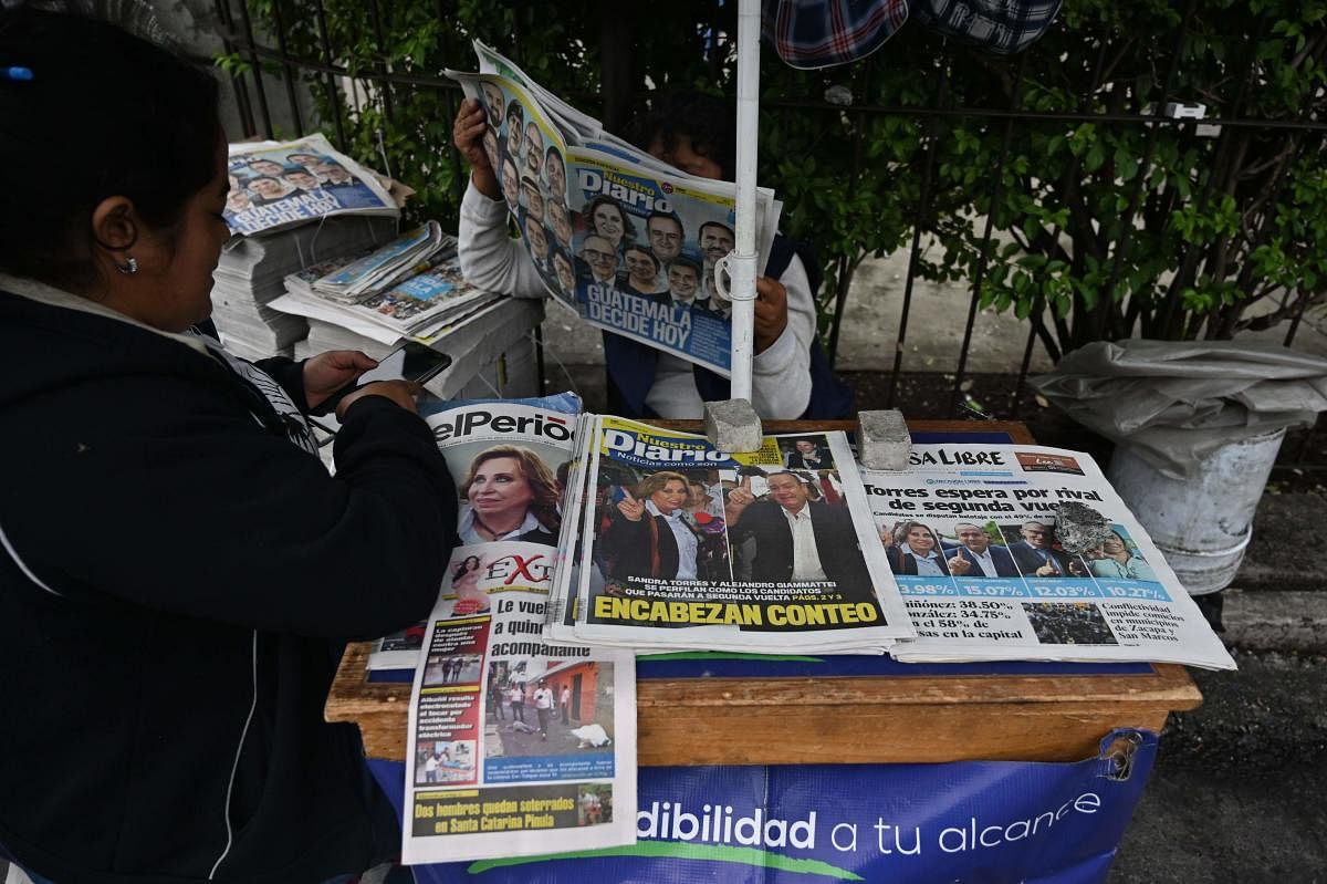 A peddler offers newspapers in Guatemala City on June 17, 2019 a day after the general election in Guatemala. (AFP)
