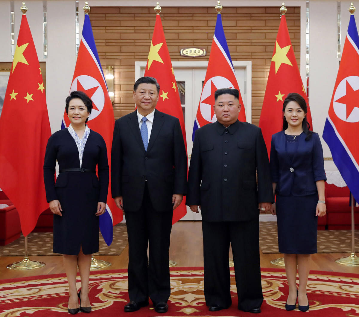 This June 20, 2019 picture released by North Korea's official Korean Central News Agency (KCNA) on June 21, 2019 shows North Korean leader Kim Jong Un, his wife Ri Sol Ju meeting Chinese President Xi Jinping  and his wife Peng Liyuan in Pyongyang. (Photo by KCNA VIA KNS / KCNA VIA KNS / AFP)