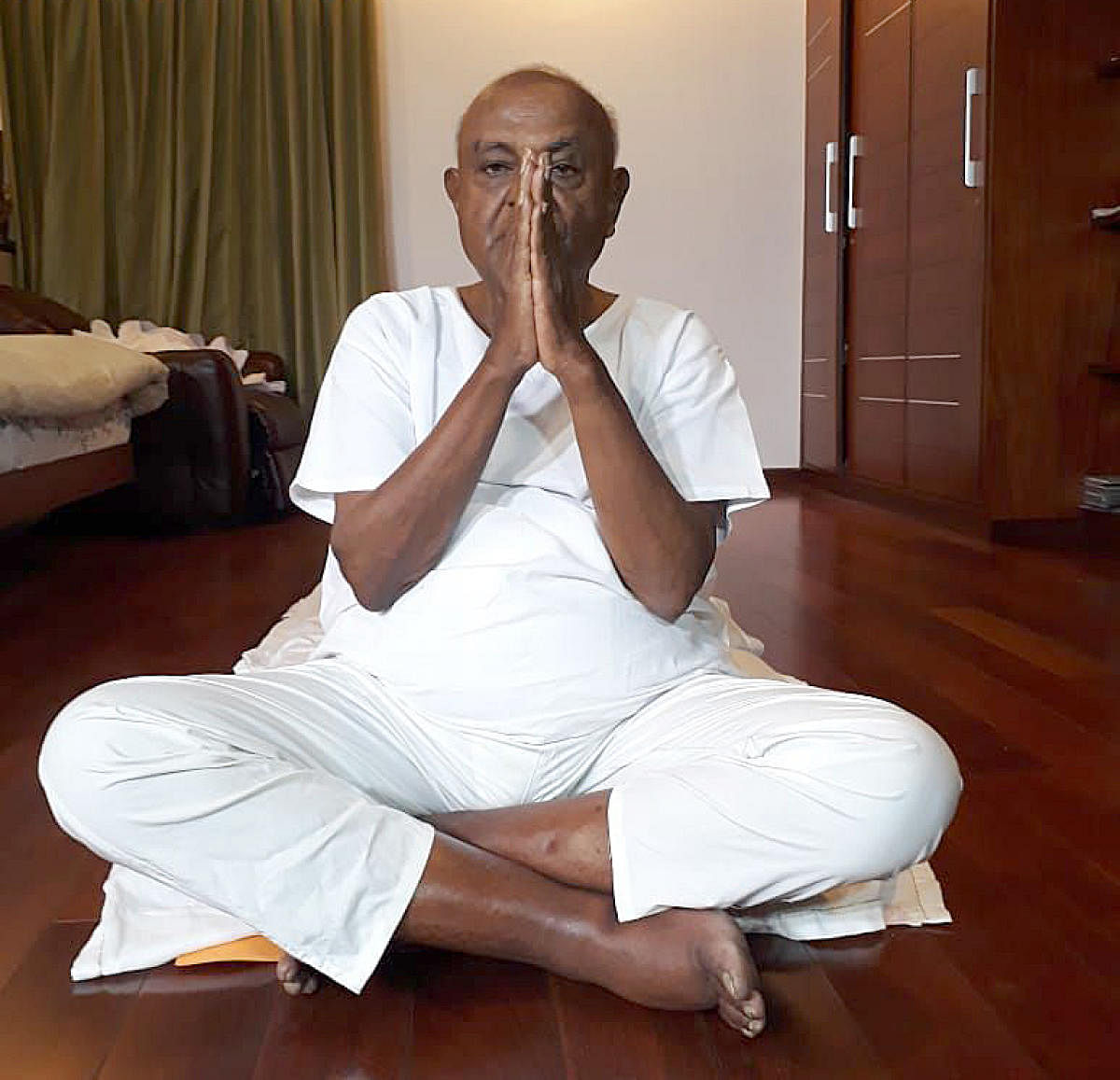 JD(S) supremo H D Deve Gowda performs yoga at his residence in Bengaluru on the occasion of International Yoga Day on Friday.