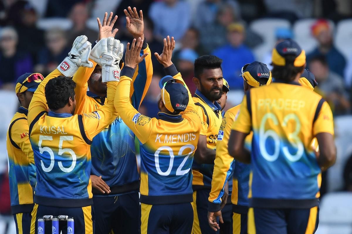 Sri Lanka's Isuru Udana (C) celebrates after taking the wicket of England's Jofra Archer for three runs during the 2019 Cricket World Cup group stage match between England and Sri Lanka at Headingley in Leeds, northern England, on June 21, 2019. (AFP)