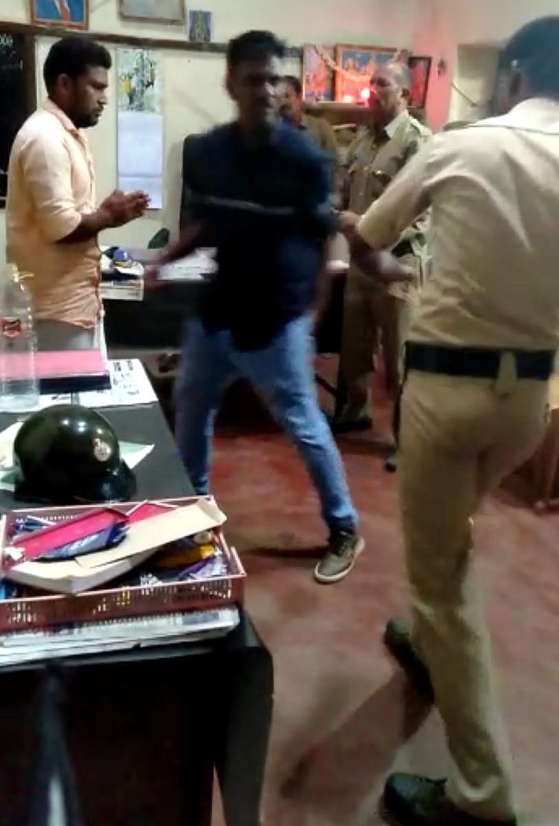 A video grab of police personnel thrashing the youth at Palibetta police station.