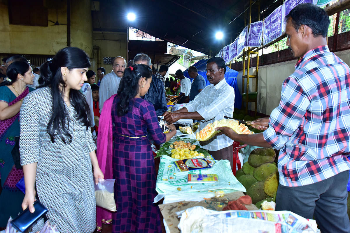 People buy jackfruit at the two-day jackfruit mela in Mangaluru on Saturday.