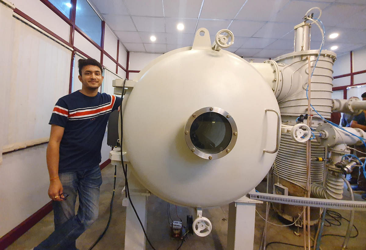 Bellatrix Aerospace CEO Rohan Ganapathy stands next to a vacuum chamber at their laboratory in Bengaluru. Reuters photo