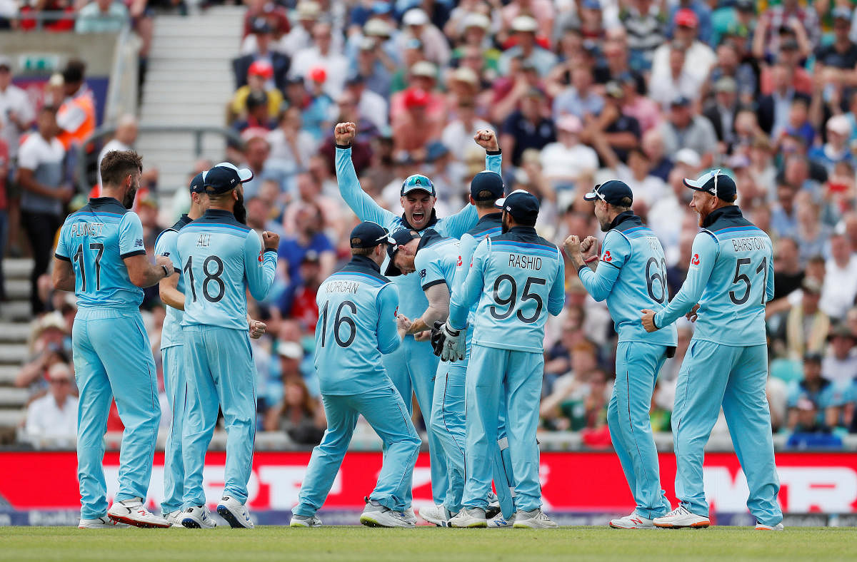 Cricket - ICC Cricket World Cup - England v South Africa - Kia Oval, London, Britain - May 30, 2019 England's Ben Stokes celebrates with Eoin Morgan and team mates after running out South Africa's Dwaine Pretorius Action Images via Reuters/Paul Childs