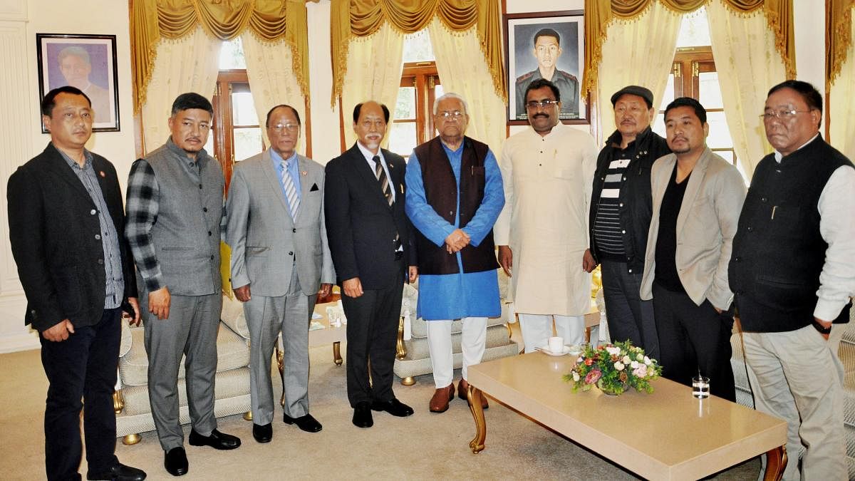 Nationalist Democratic Progressive Party leader Neiphiu Rio with BJP general secretary Ram Madhav, JD (U) elected candidate G Kaito Aye, Independent MLA Tongpang Ozukum and NDPP-BJP state officials pose with Governor of Nagaland PB Acharya at Raj Bhavan,