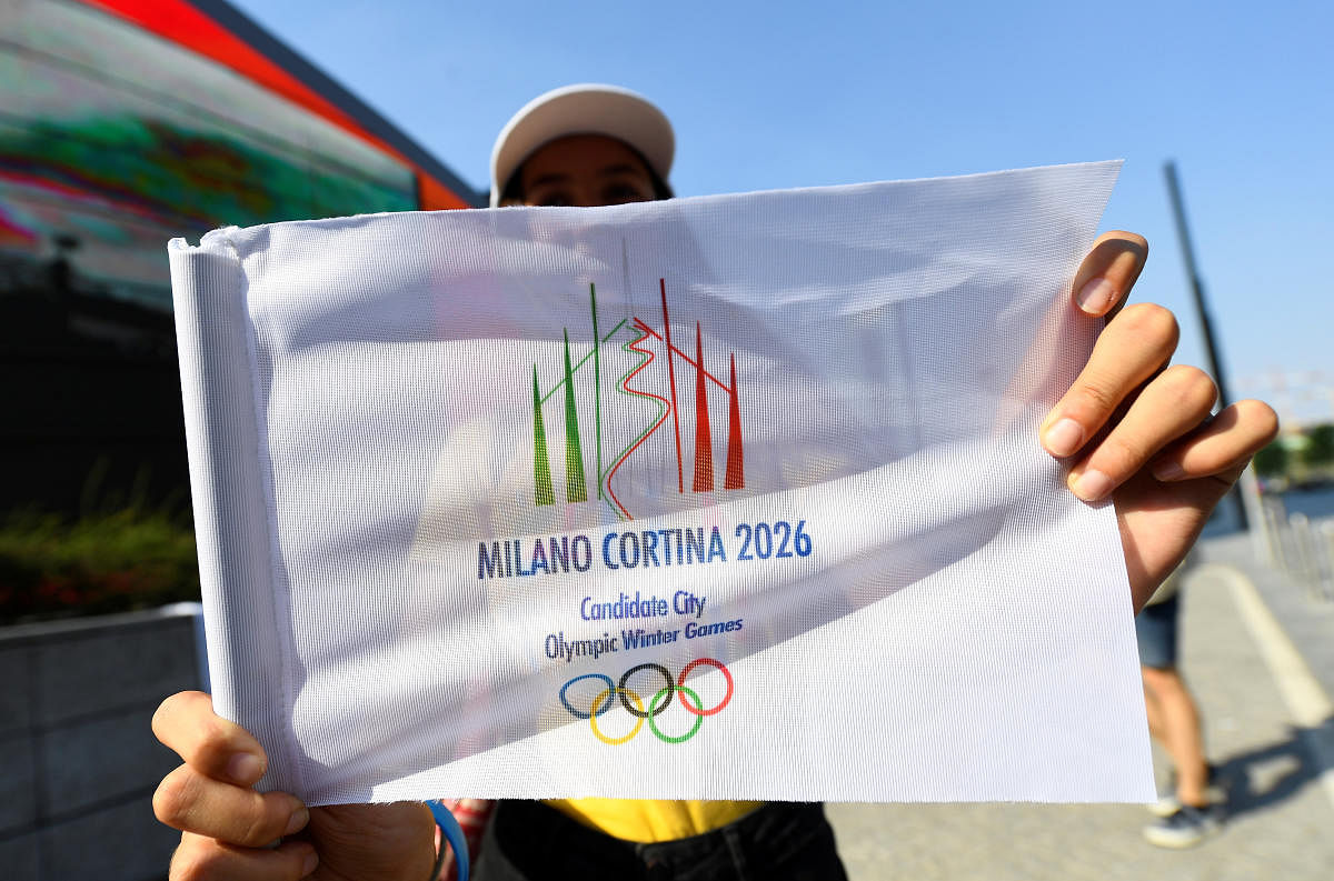 Athletics - Italians react to the announcement of the host city for the 2026 Winter Olympic Games - Milan, Italy - June 24, 2019 The logo for Milan-Cortina D'Ampezzo 2026 Winter Olympic Games is displayed as Italians celebrate after it was announced as th