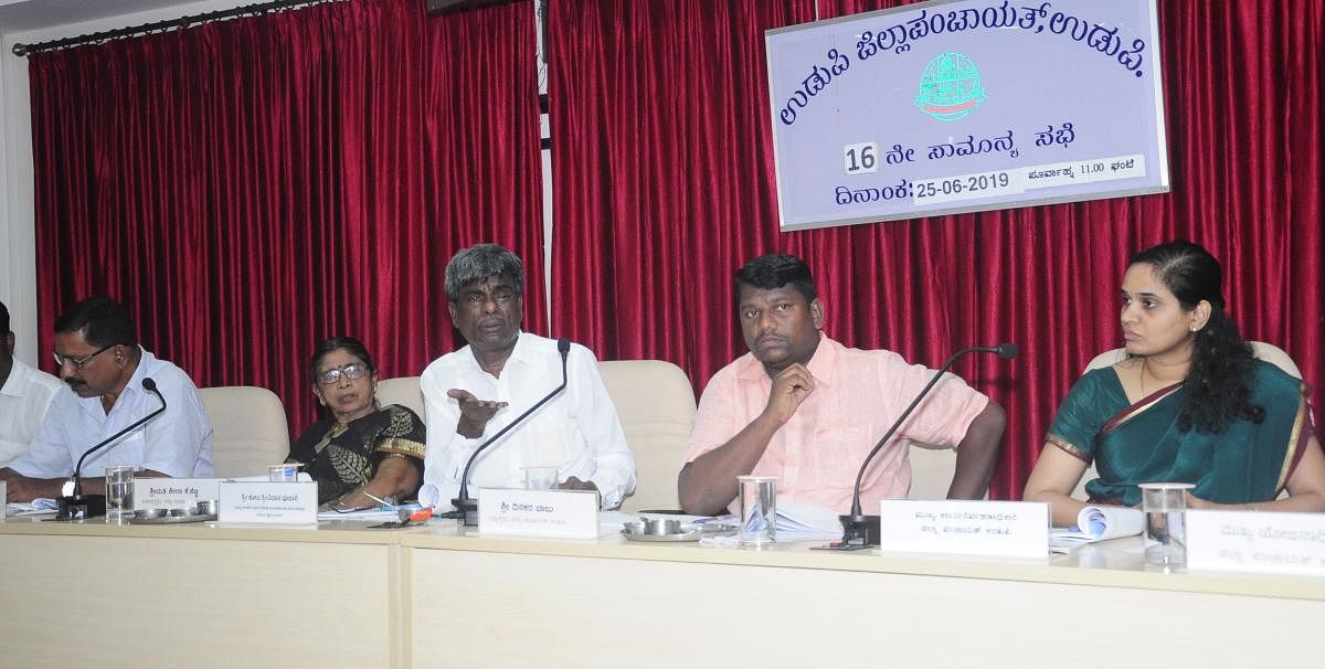 Leader of Opposition in Legislative Council Kota Srinivas Poojary speaks at the Zilla Panchayat's general meeting in Udupi on Tuesday. DH photo